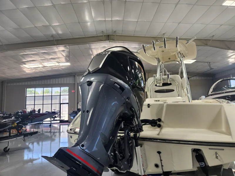 Slide: The Image of 2025 Pathfinder 2400 Open boat with powerful outboard motor in showroom. - 8