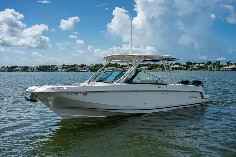 Slide: The Image of 2018 Boston Whaler 270 Vantage boat on calm water under blue sky. - 10