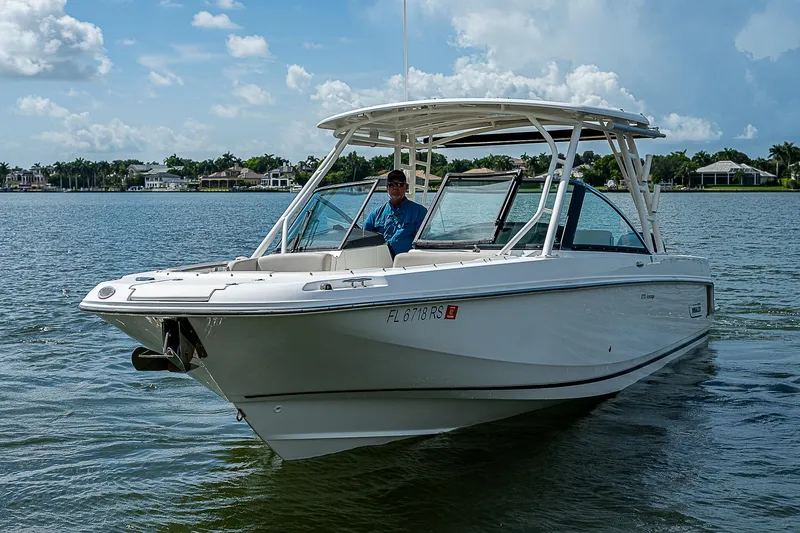 Slide: The Image of 2018 Boston Whaler 270 Vantage boat cruising on a sunny lake. - 12