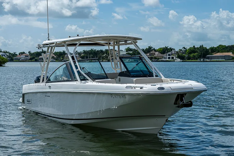 Slide: The Image of 2018 Boston Whaler 270 Vantage boat on a calm lake under a blue sky. - 14