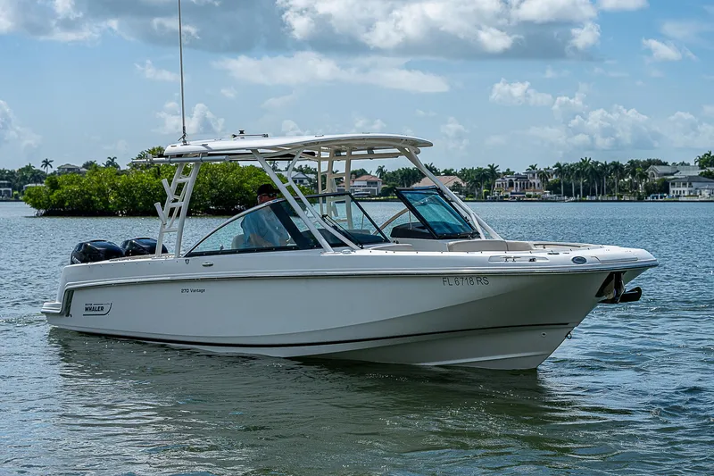 Slide: The Image of 2018 Boston Whaler 270 Vantage boat on calm water under a cloudy sky. - 15