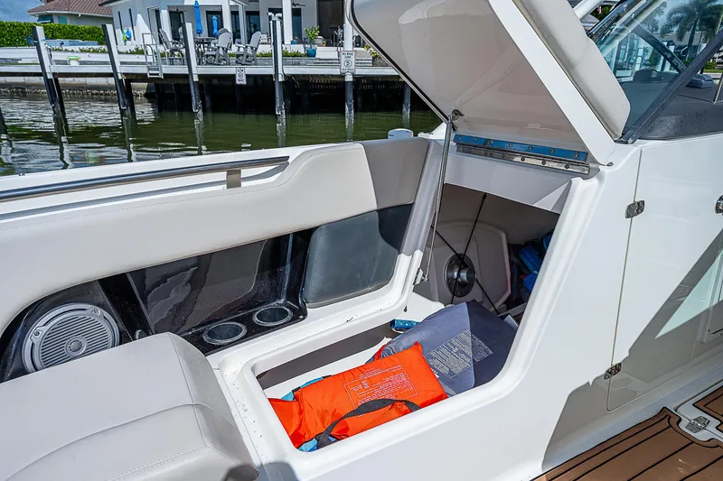 Slide: The Image of 2018 Boston Whaler 270 Vantage boat with open storage compartment and life jacket. - 19