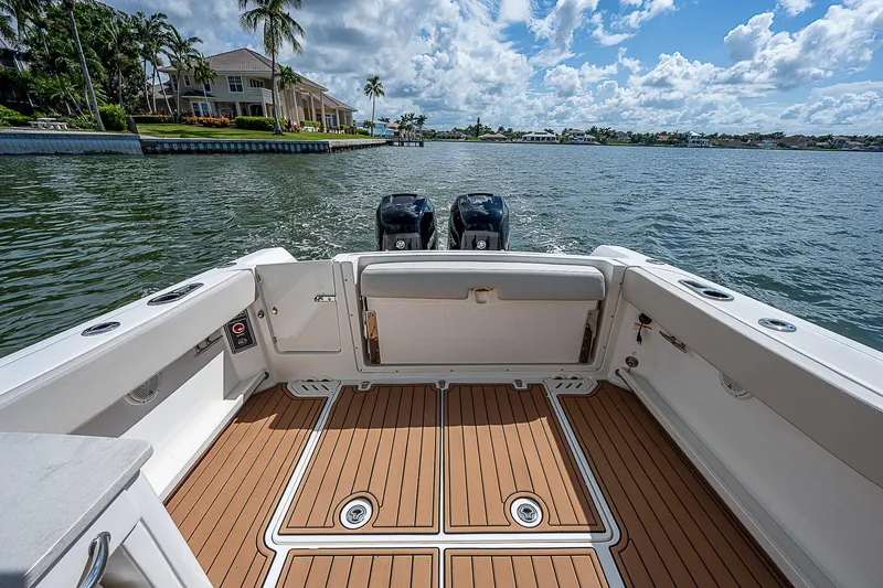 Slide: The Image of 2018 Boston Whaler 270 Vantage boat interior with dual engines on a sunny day. - 22