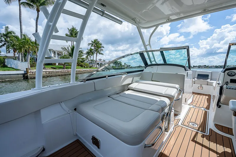 Slide: The Image of 2018 Boston Whaler 270 Vantage boat interior with luxurious seating and scenic waterfront view. - 26