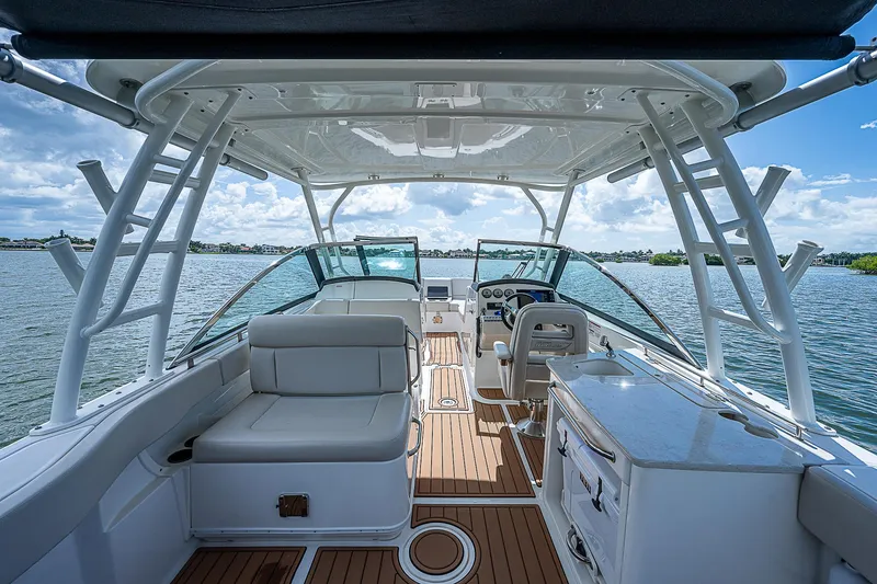 Slide: The Image of 2018 Boston Whaler 270 Vantage boat interior with seating and helm, on open water. - 28