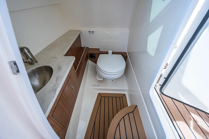 Slide: The Image of 2018 Boston Whaler 270 Vantage boat bathroom with sink and toilet. - 32