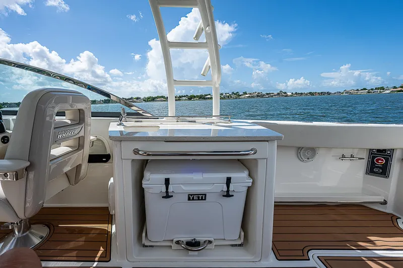 Slide: The Image of 2018 Boston Whaler 270 Vantage boat interior with Yeti cooler and scenic water view. - 38