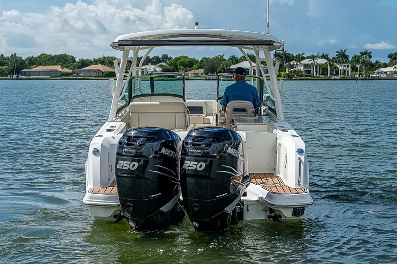 Slide: The Image of 2018 Boston Whaler 270 Vantage boat with dual 250 engines on a calm lake. - 4