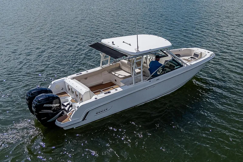 Slide: The Image of 2018 Boston Whaler 270 Vantage boat on water, featuring dual Mercury engines. - 41