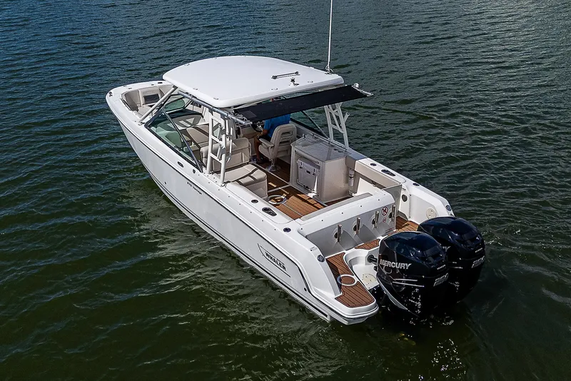 Slide: The Image of 2018 Boston Whaler 270 Vantage boat on water with twin Mercury engines. - 44
