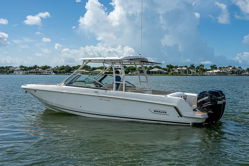Slide: The Image of 2018 Boston Whaler 270 Vantage boat on calm water under a blue sky. - 7