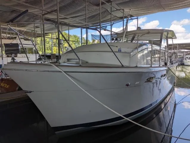 The Image of 1972 Chris-Craft 41 Commander yacht docked under a covered marina. - 1