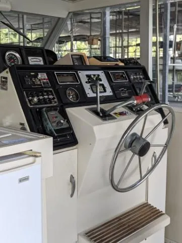 Slide: The Image of 1972 Chris-Craft 41 Commander helm with steering wheel and control panel. - 10
