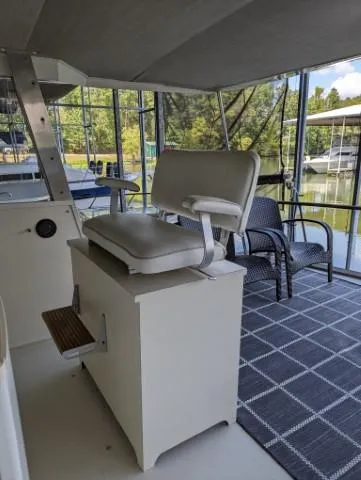 Slide: The Image of 1972 Chris-Craft 41 Commander helm with cushioned seat, overlooking marina and water. - 11