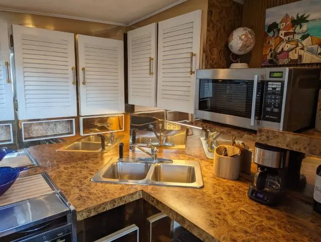 Slide: The Image of 1972 Chris-Craft 41 Commander kitchen with dual sinks, microwave, and coffee maker. - 15
