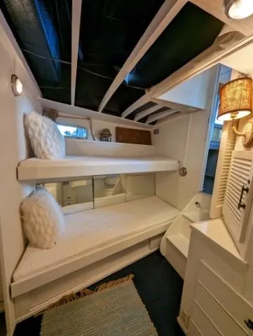 Slide: The Image of 1972 Chris-Craft 41 Commander interior with cozy bunk beds and nautical decor. - 18