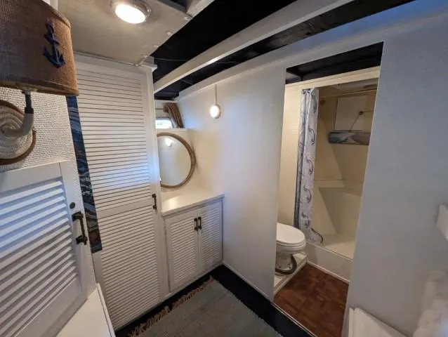 Slide: The Image of 1972 Chris-Craft 41 Commander bathroom with nautical decor and compact shower area. - 19