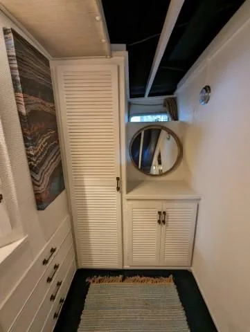 Slide: The Image of Interior of 1972 Chris-Craft 41 Commander with storage cabinets and round mirror. - 20