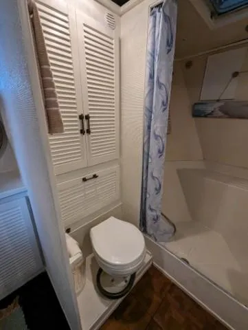 Slide: The Image of 1972 Chris-Craft 41 Commander bathroom with shower, toilet, and storage cabinets. - 21