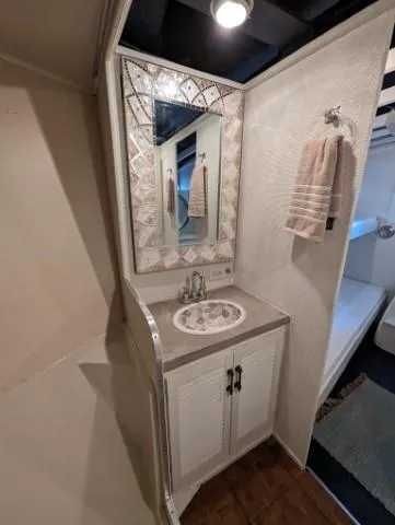 Slide: The Image of 1972 Chris-Craft 41 Commander bathroom with sink, mirror, and towel. - 22