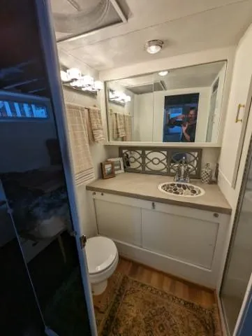 Slide: The Image of 1972 Chris-Craft 41 Commander bathroom with mirror, sink, and toilet. - 24