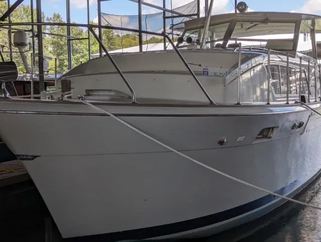Slide: The Image of 1972 Chris-Craft 41 Commander yacht docked in a marina, side view. - 4