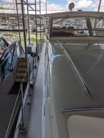 Slide: The Image of 1972 Chris-Craft 41 Commander docked at marina, showcasing sleek design and classic features. - 7