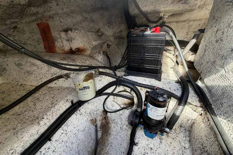 Slide: The Image of 2021 Glasstream 280 SCX boat interior showing battery, wiring, and Sierra filter system. - 103