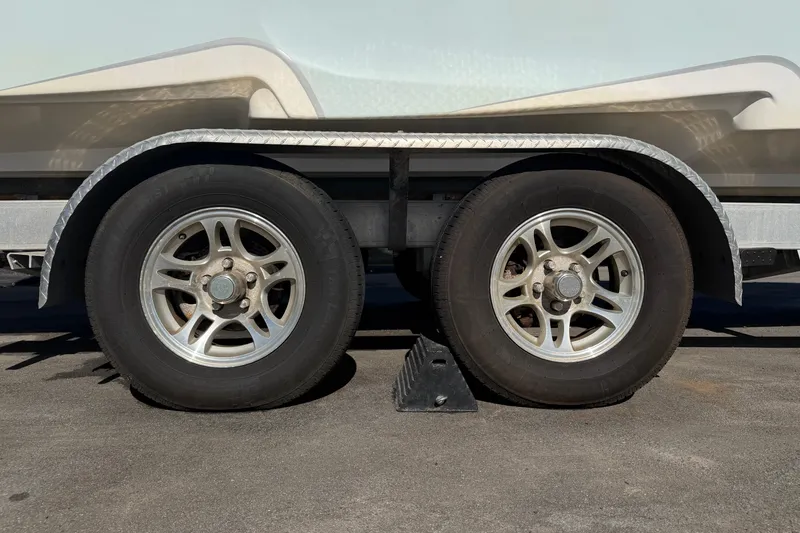 Slide: The Image of Trailer wheels of a 2021 Glasstream 280 SCX boat, secured with a wheel chock. - 107