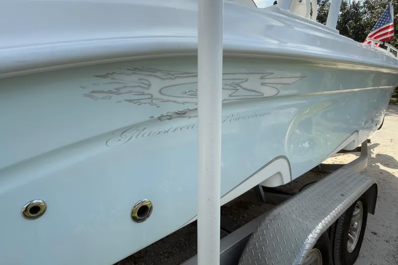 Slide: The Image of 2021 Glasstream 280 SCX boat on trailer, side view, clear sky background. - 18