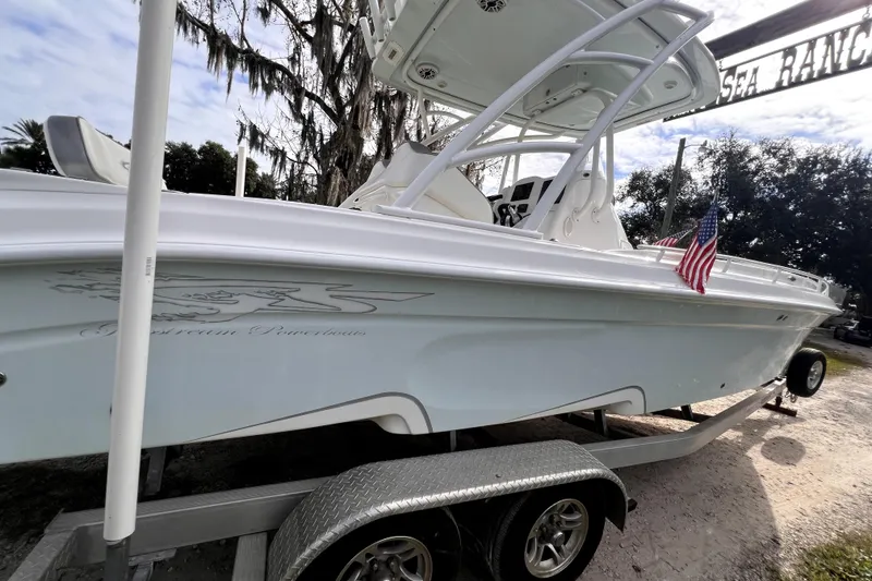 Slide: The Image of 2021 Glasstream 280 SCX boat on display under a clear blue sky. - 19