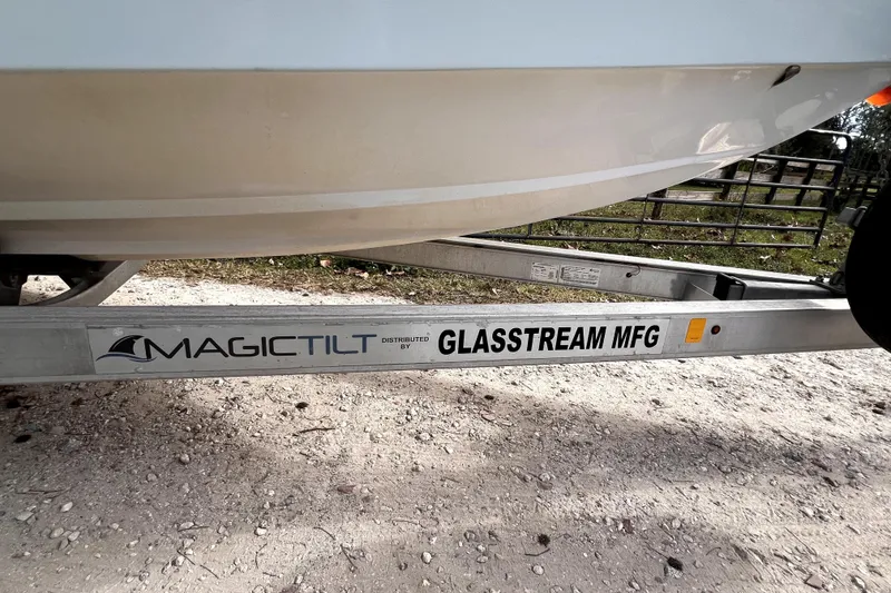 Slide: The Image of 2021 Glasstream 280 SCX boat interior with seating and helm, displayed outdoors. - 20