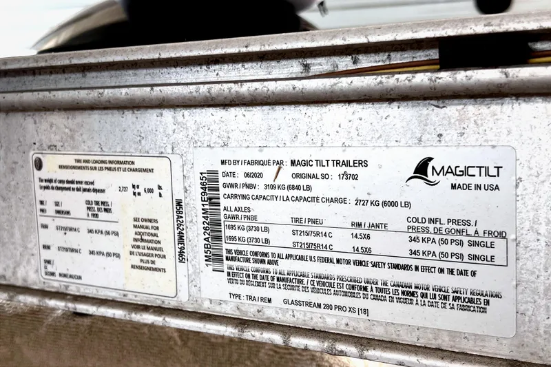 Slide: The Image of 2021 Glasstream 280 SCX boat interior with seating and control panel, docked outdoors. - 21