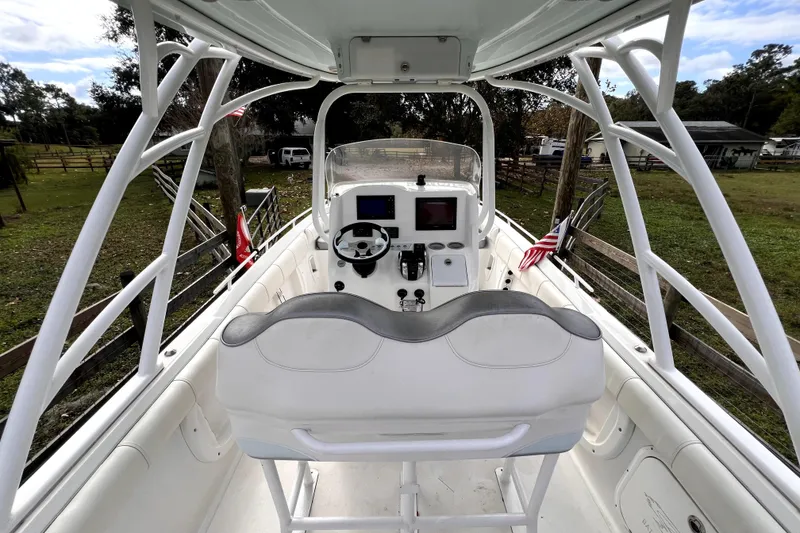 Slide: The Image of 2021 Glasstream 280 SCX boat interior with helm, speakers, and clear sky view. - 25