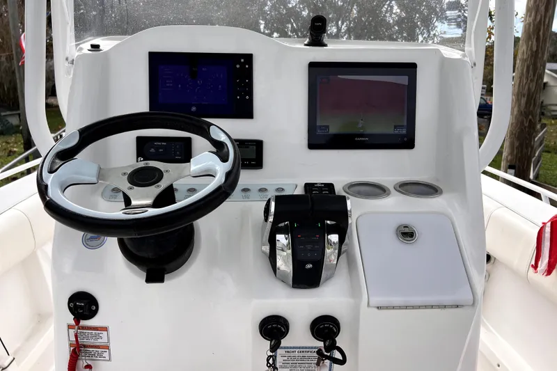 Slide: The Image of 2021 Glasstream 280 SCX boat cockpit with Garmin navigation, steering wheel, and seating. - 26