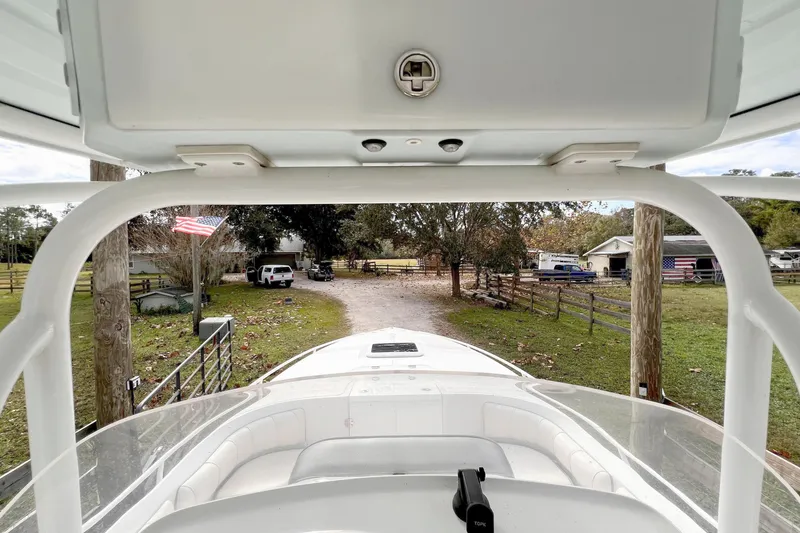 Slide: The Image of 2021 Glasstream 280 SCX boat interior view with clear sky and parked boats. - 28