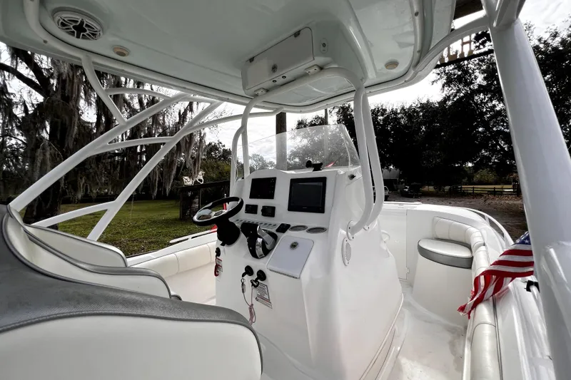 Slide: The Image of Control panel of 2021 Glasstream 280 SCX boat with various switches and a Fusion audio system. - 35