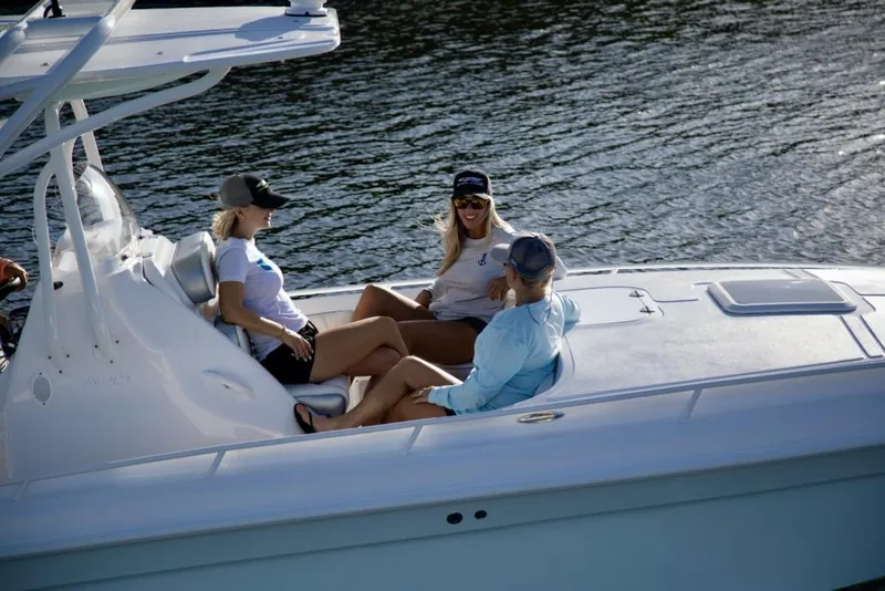 Slide: The Image of 2021 Glasstream 280 SCX boat with dual outboard engines, parked under a clear blue sky. - 5