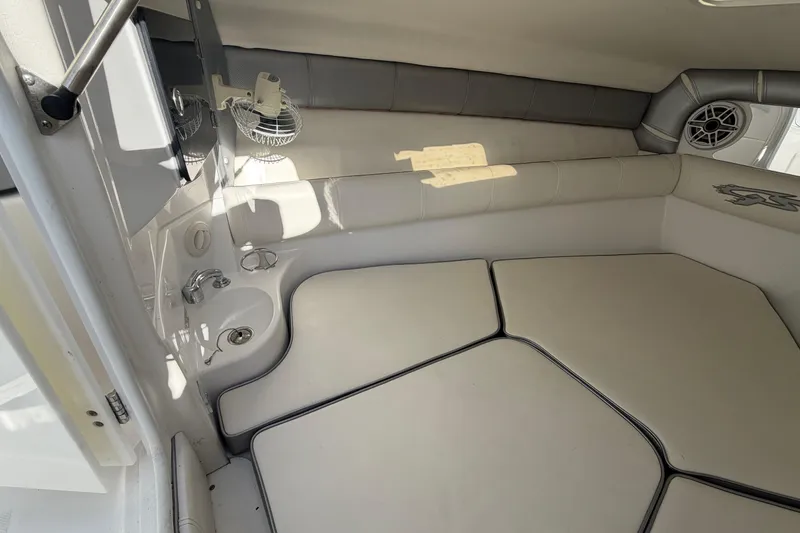 Slide: The Image of 2021 Glasstream 280 SCX cabin interior with cushioned seating and compact amenities. - 51