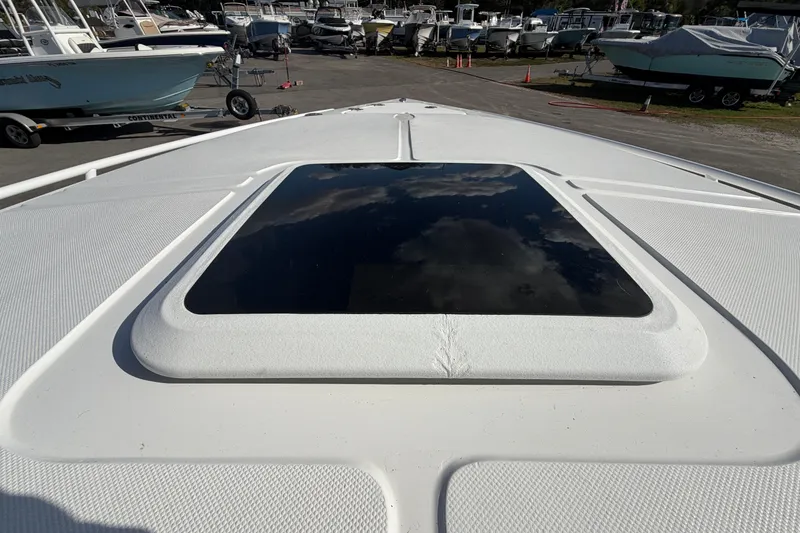 Slide: The Image of 2021 Glasstream 280 SCX boat deck with a reflective hatch, surrounded by other boats. - 61