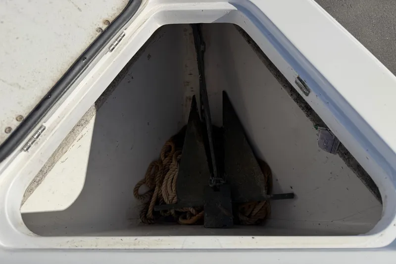 Slide: The Image of Anchor storage compartment on a 2021 Glasstream 280 SCX boat, featuring rope and anchor. - 64