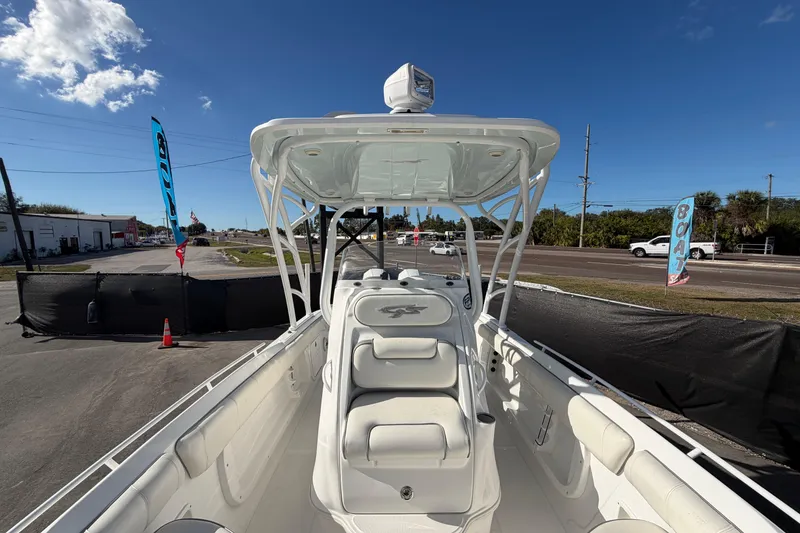 Slide: The Image of 2021 Glasstream 280 SCX boat with sleek design, parked outdoors under clear blue sky. - 68