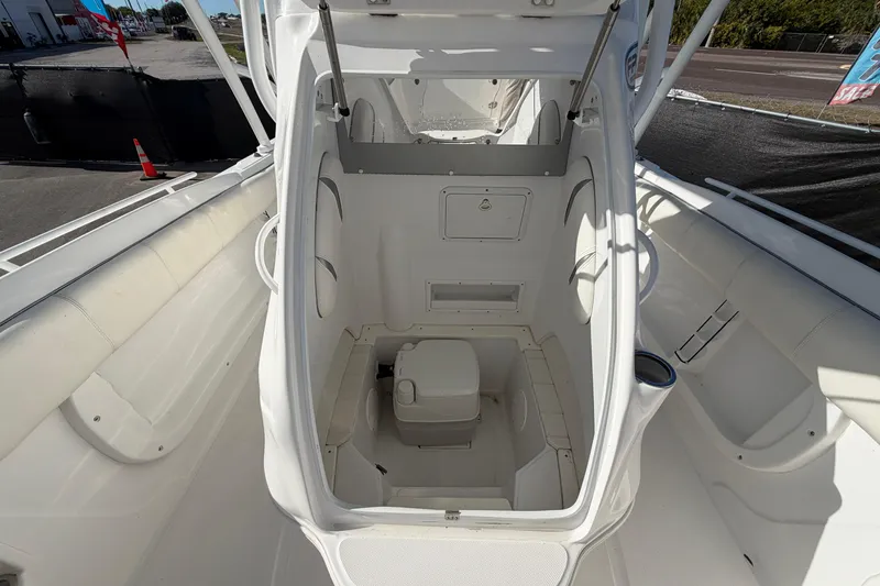 Slide: The Image of 2021 Glasstream 280 SCX boat interior with compact toilet and seating area. - 74