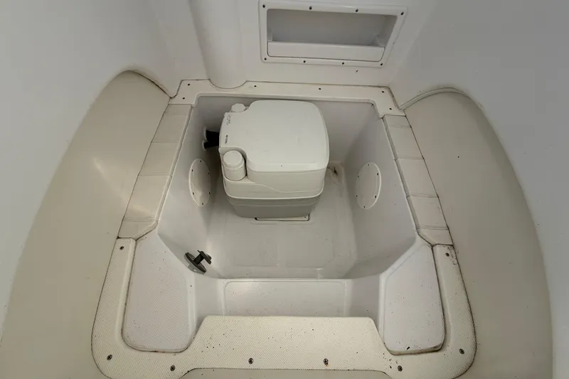 Slide: The Image of 2021 Glasstream 280 SCX boat interior with portable toilet in compartment. - 75