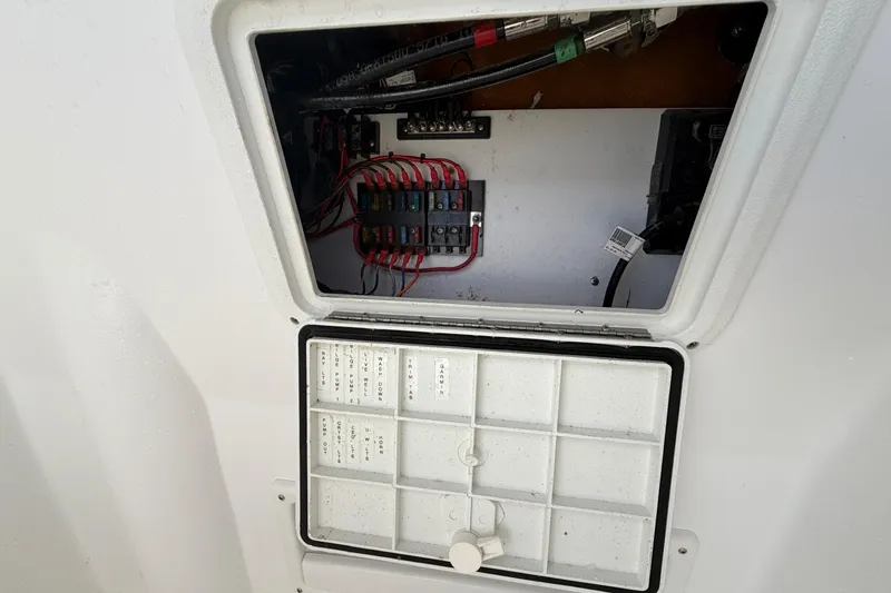 Slide: The Image of Electrical panel inside a 2021 Glasstream 280 SCX boat, showing wiring and components. - 77