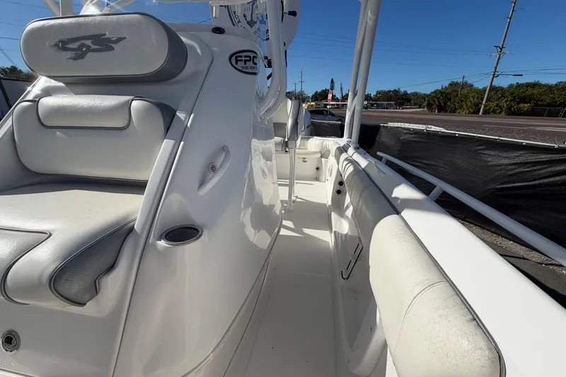 Slide: The Image of 2021 Glasstream 280 SCX boat interior with white seating and console, under clear blue sky. - 79