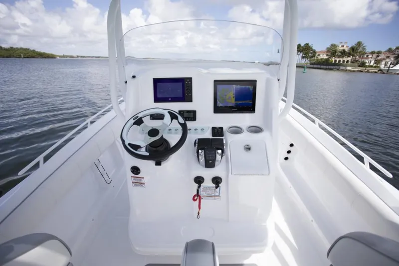 Slide: The Image of 2021 Glasstream 280 SCX boat with dual Mercury outboard engines, parked under a clear sky. - 8