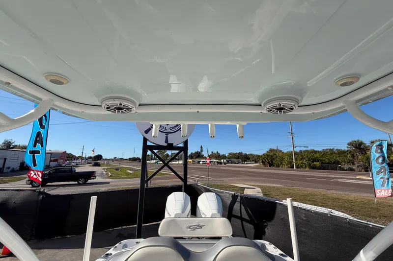 Slide: The Image of 2021 Glasstream 280 SCX boat interior with speakers and seating, displayed at a sales lot. - 80