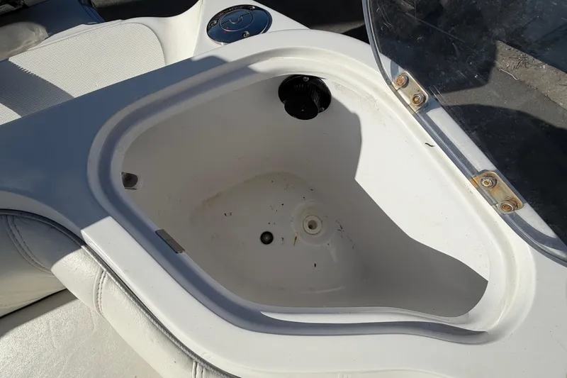 Slide: The Image of Open storage compartment on 2021 Glasstream 280 SCX boat, featuring white interior. - 97