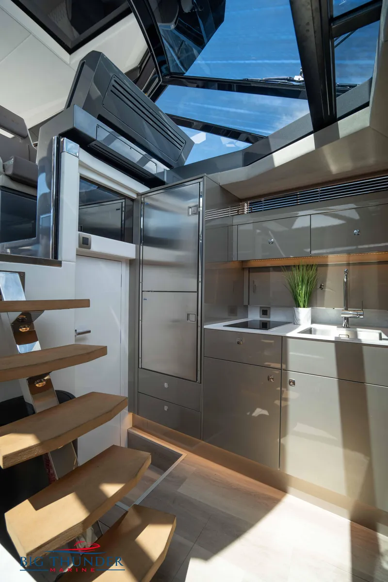 Slide: The Image of Modern yacht interior with sleek kitchen design, featuring skylights and wooden stairs, 2024 Dutch American Iconic DA 50. - 44